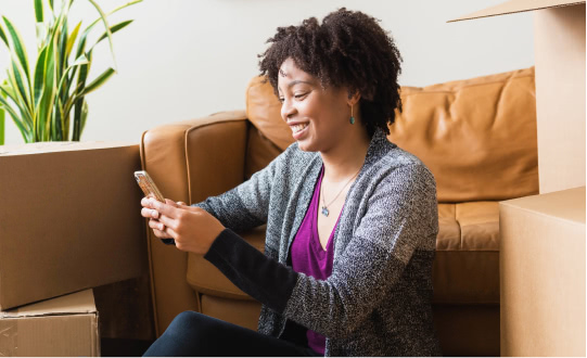 Woman using her phone to book a Tasker.